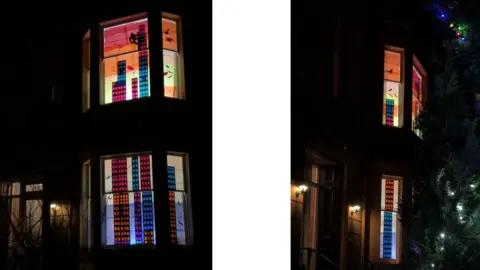 Using coloured tissue and lamps, the couple created a glowing skyline scene