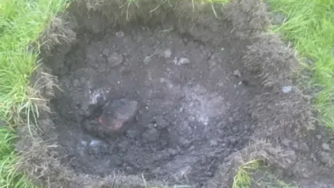 Gill Shilvock A crater left by a controlled explosion when bomb disposal experts dealt with a grenade in Cradley Heath