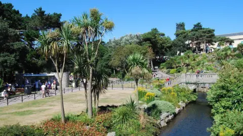 Barry Shimmon/Geograph Bournemouth's Lower Gardens, showing the River Bourne running alongside rich green plants
