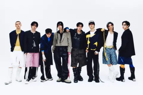 JYP Entertainment Promotional photo for Stray Kids, showing all members standing together against a white backdrop