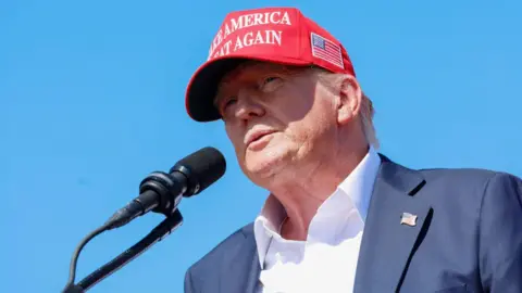 Getty Images Donald Trump stands behind a microphone