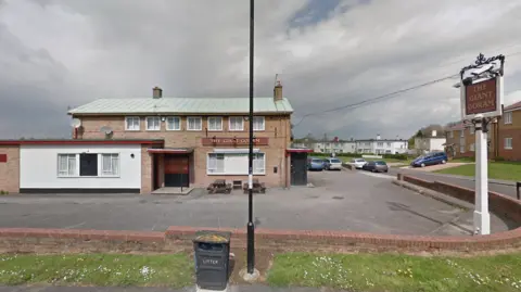 Google A building with a red sign which reads 'The giant goram'