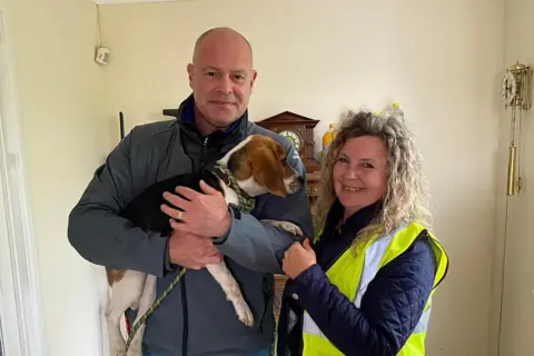 Kim Jefcott Phil James and Kim Jefcott holding a dog they helped find