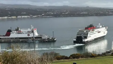 The Manxman ferry leaving Douglas Harbour with the Ben-My-Chree moored tot he left.