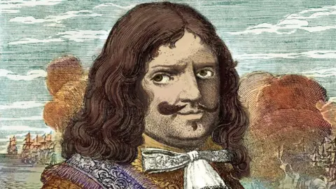 Getty Images A colourized portrait of Sir Henry Morgan. He has long, flowing brown hair and and moustache and goatee. He is wearing a yellow top, has a purple sash and a white bowtie. In the background there is a river with some ships sailing away as well as several autumnal trees.