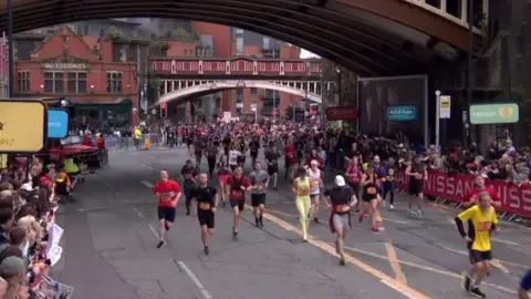 runners reach finish line on Deansgate