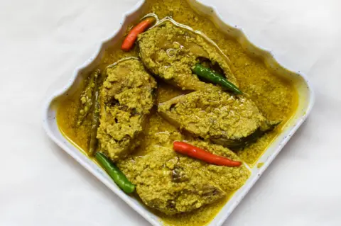 Getty Images Sorshe Illish or Hilsa fish Curry with mustard seed. famous Bengali & Indian food.