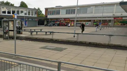 A square surrounded by shop fronts