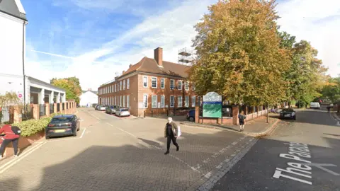 A brick building with white windows. 