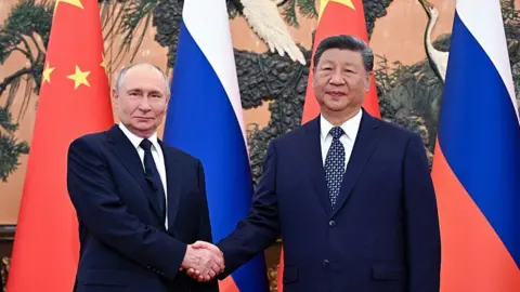Getty Images In this pool photograph distributed by the Russian state agency Sputnik, Russia's President Vladimir Putin (L) shakes hands with China's President Xi Jinping during a meeting at The Great Hall of the People in Beijing on September 2, 2025.