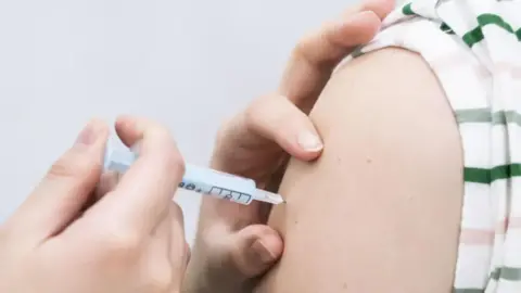 A needle going into someone's arm