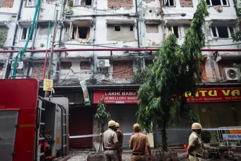 Firefighters inspect the aftermath of a hotel fire that killed several people in Kolkata, India, April 30, 2025. REUTERS/Sahiba Chawdhary