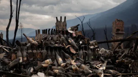 Reuters Burned wine bottles at a hotel destroyed by fire in Jasper