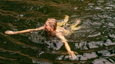 A woman swimming in river