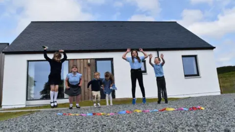 Sabhal Mòr Ostaig Children outside new home at Kilbeg