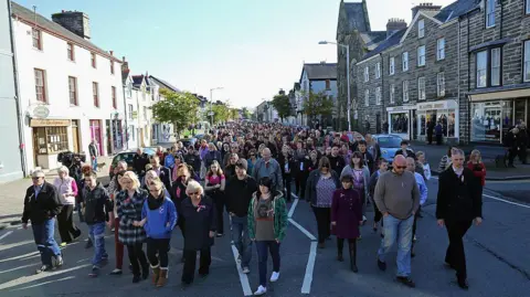 Getty Images Members of the community of Machynlleth walk together to St Peter's Church for a service with prayers for missing five-year-old April Jones on October 7, 2012 in Machynlleth, Wales. Hundreds of local people walked from April's home in Bryn-y-Gog to the local church in the centre of Machynlleth where the Bishop of Bangor Andrew John officiated. Police have charged local man Mark Bridger with murder, child abduction and attempting to pervert the course of justice. Five-year-old April Jones was abducted from outside her house on Monday night in Machynlleth.