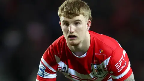 George Delaney in action for St Helens in their red and white home shirt