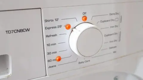 Sense A washing machine has orange bumpy dots next to settings on a dial.