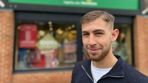 George Carden / BBC A shopper outside Jempsons store in Rye