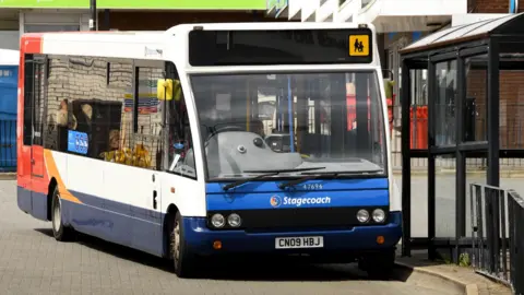 Getty Images A Stagecoach bus parked next to a bus stop on the street.