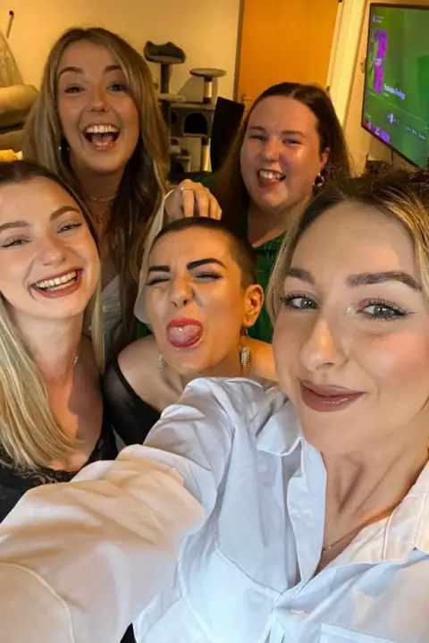 Sophie Morgan Sophie Morgan (centre) poses with four of her friends. She pokes her tongue out while the rest of her friends smile at the camera. 