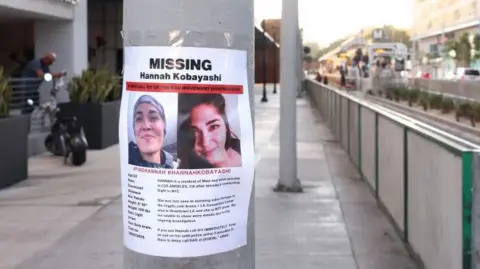 Flyers mentioning missing Maui woman Hannah Kobayashi hang on a lamppost near the metro station where she was last seen in Los Angeles