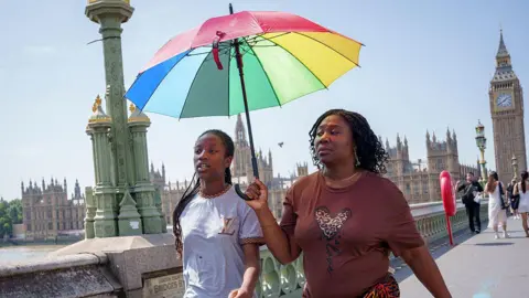 In the picture via Getty's picture two girls crossminster jumps of westminster crossminter to shake them from the sun