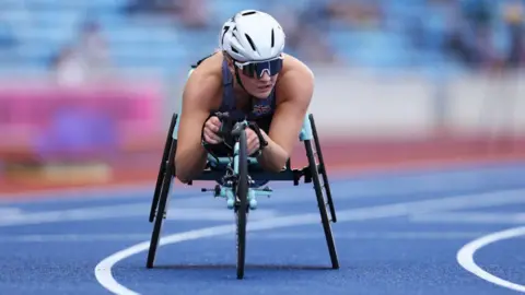 A paralympian racing in a specially adapted wheelchair.