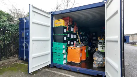 Ben Moore /  BBC Image of a shipping container with boxes of tools inside. 