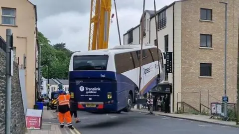 Derry Journal bus being lifted by crane