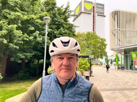 Stephen Aslin, wearing a white helmet and blue body-warmer,