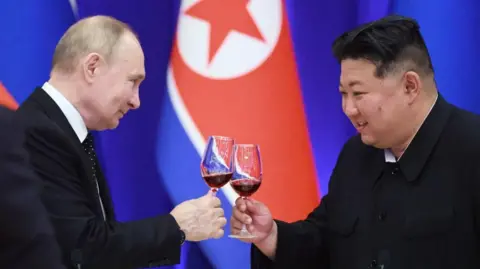 Getty Images Soviet President Vladimir Putin and North Korean leader Kim Jong Un toast during a banquet at the Mongnangwan Reception House in Pyongyang on June 19, 2024.