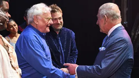 Jeff Spicer via Getty Images King Charles III greets director Sir Richard Eyre and Sir Kenneth Branagh after a performance of The Tempest at the Royal Shakespeare Theatre.
