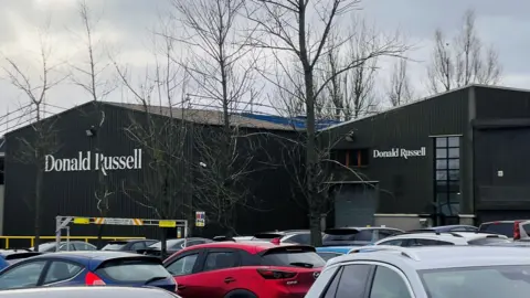 The Donald Russell business in Inverurie, with cars in the foreground.