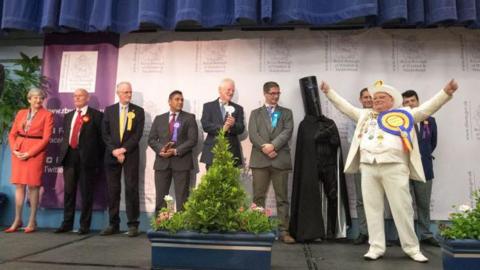 British Prime Minister and Conservative Party leader Theresa May (far left) stands with other candidates at the declaration at the election count at the Magnet Leisure Centre during the 2017 general election