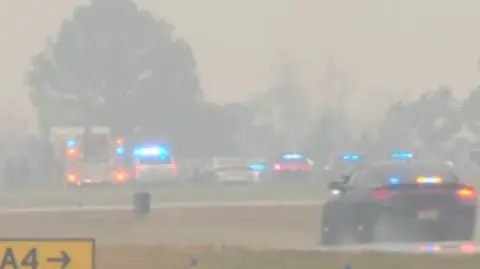 CBS Police car and ambulances near the crash site