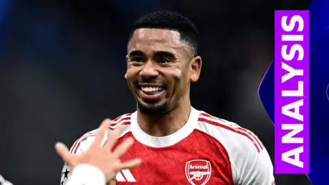 Gabriel Jesus smiles in red and white Arsenal kit