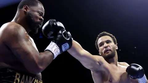 Moses Itauma lands a punch on Jermain Franklin during their fight in Manchester