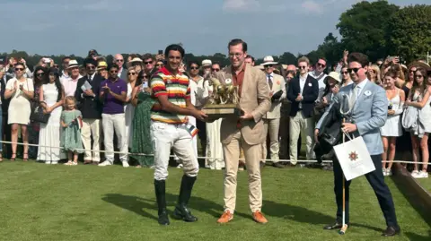 Crowds of people look on as the The Maharaja of Jaipur receives  The Jaipur Trophy
