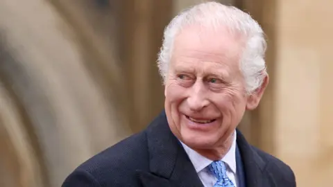 PA Media A smiling King Charles in a head and shoulders photograph, taken in May 2024