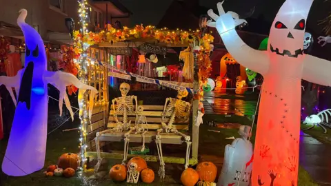 An array of Halloween decorations, including inflatable ghosts, pumpkins and skeletons.