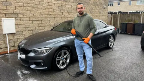 Aston Grisdale pictured in front of his BMW