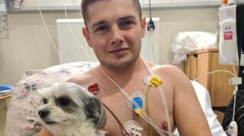 Louis in hospital with his beloved dog
