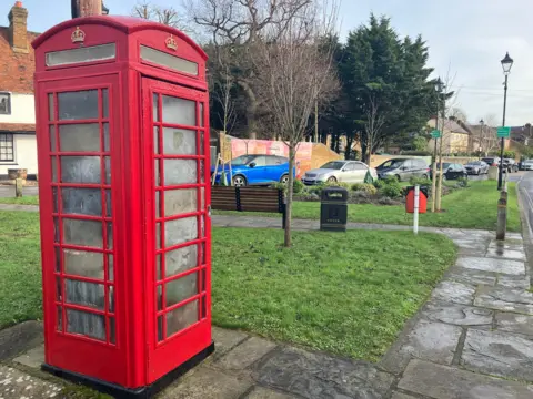 Red telephone box on Harmondsworth village green