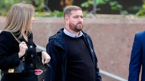 PA Media David Chambers,  who has brown hair swept to one side and a short brown beard, leaving Liverpool Crown Court