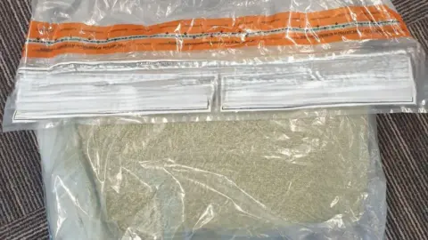 Devon and Cornwall Police A plastic zip-lock bag is seen containing a grainy substance reported to be spice 
