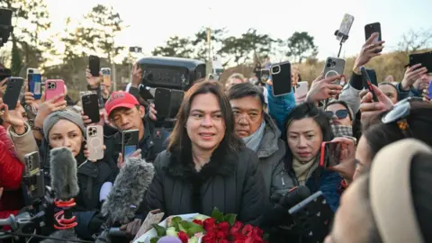 Getty Images Vice-president of Philippines Sara Duterte speaks as large crowds gather outside the International Criminal Court (ICC) on the day of her father's hearing in the Hague, Netherlands on March 14, 2025.