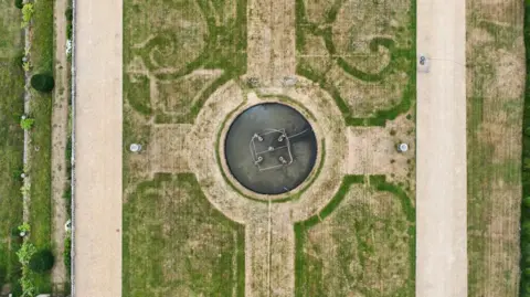 Scorched grass at Chatsworth reveals an outline of an ornate 17th-century garden. 