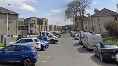 A street with car parking spaces on both sides 