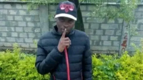 Boniface Kariuki in a black jacket and cap